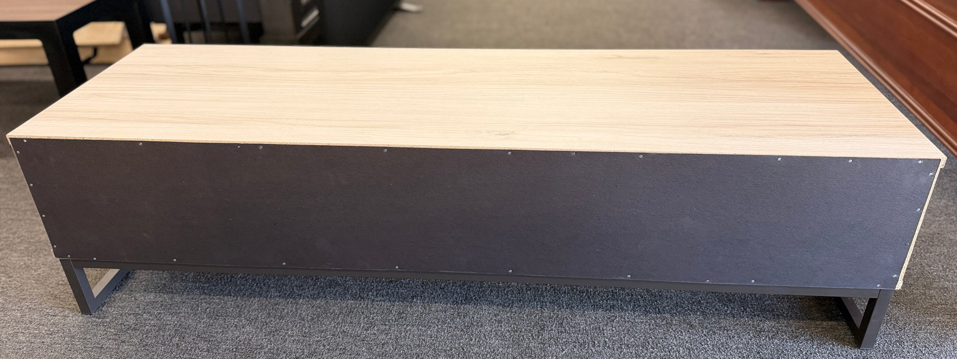 A contemporary, low-profile 53-inch TV stand with two wide drawers, sleek black bar pull handles, and a slim black metal base frame.