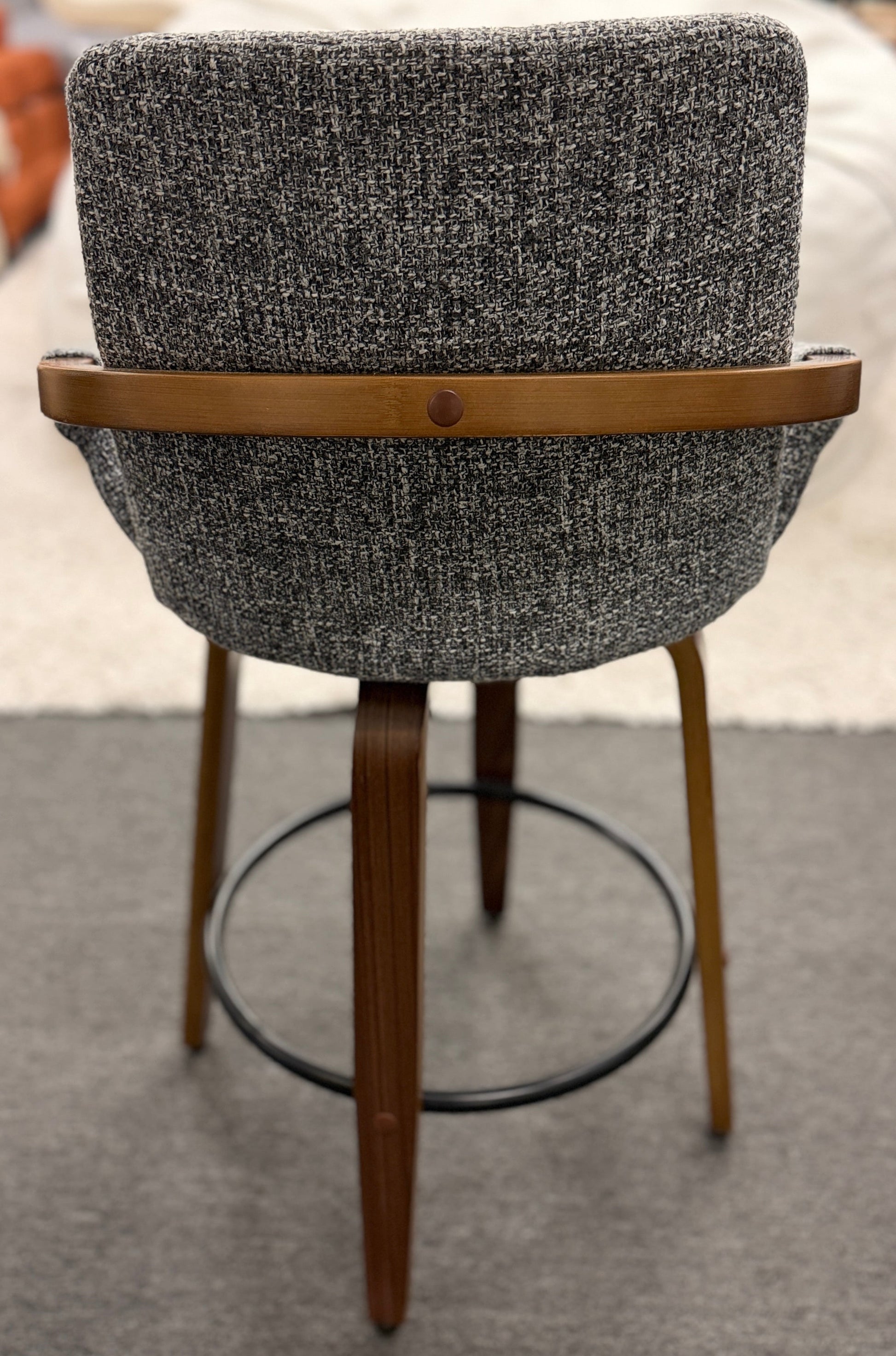 A 3-piece set of mid-century modern barstools featuring textured gray tweed upholstered seats, curved walnut wood armrests, and tapered legs with a black metal footrest ring.