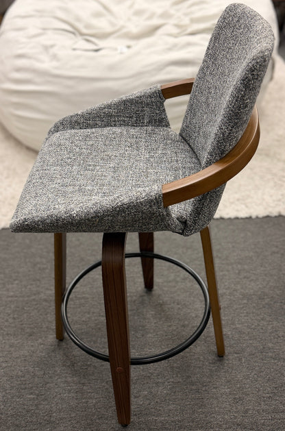 A 3-piece set of mid-century modern barstools featuring textured gray tweed upholstered seats, curved walnut wood armrests, and tapered legs with a black metal footrest ring.