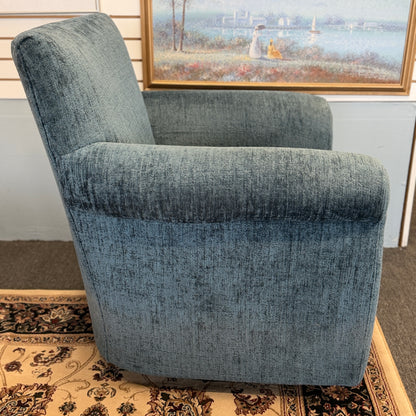 A premium Arhaus plush upholstered swivel armchair in excellent condition, featuring rolled arms, a thick seat cushion, and a high backrest.