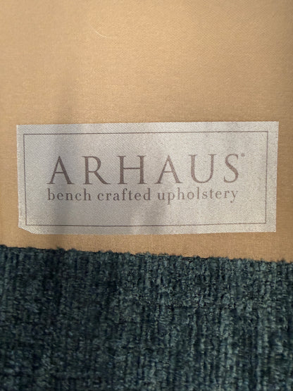 A premium Arhaus plush upholstered swivel armchair in excellent condition, featuring rolled arms, a thick seat cushion, and a high backrest.