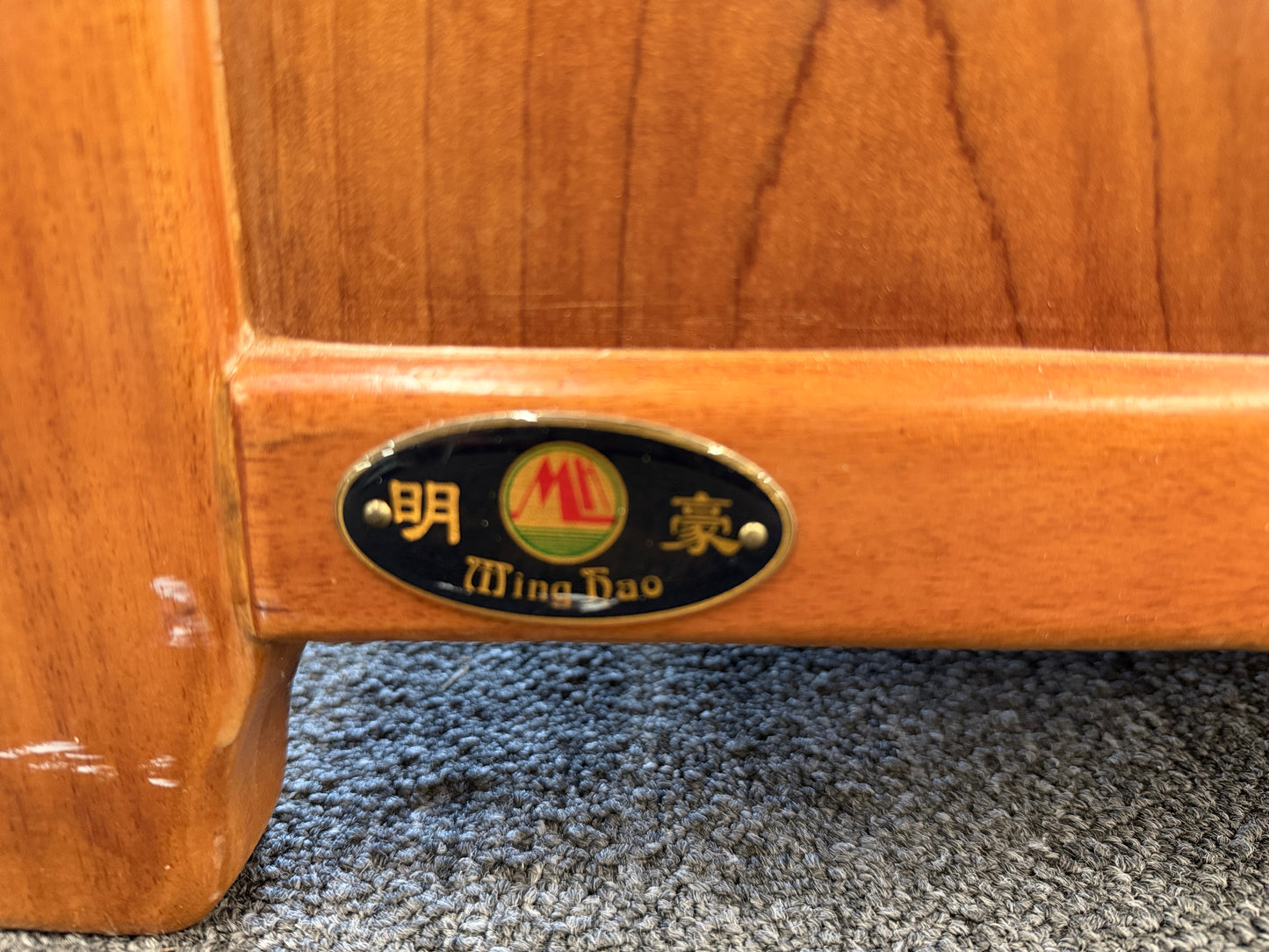 A mid-century modern full bed frame made of wood, featuring a gently curved headboard, footboard, and a sturdy interior slatted support base.