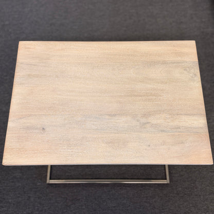 A minimalist C-shaped end table with a wooden tabletop and a slender black metal frame designed to slide over a sofa arm.
