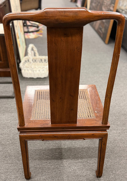 A 9-piece traditional wooden dining set featuring a large rectangular table, two matching armchairs, and six side chairs with woven rattan backrests.