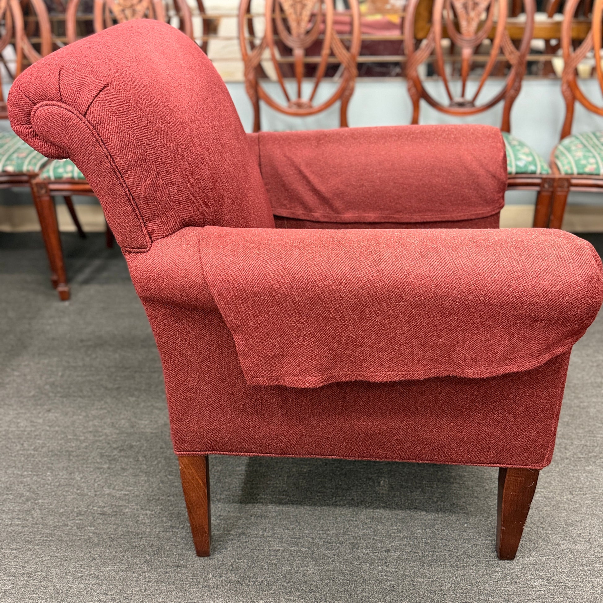 A contemporary plush fabric armchair featuring wide rounded track arms, a T-cushion seat, and a supportive square backrest.