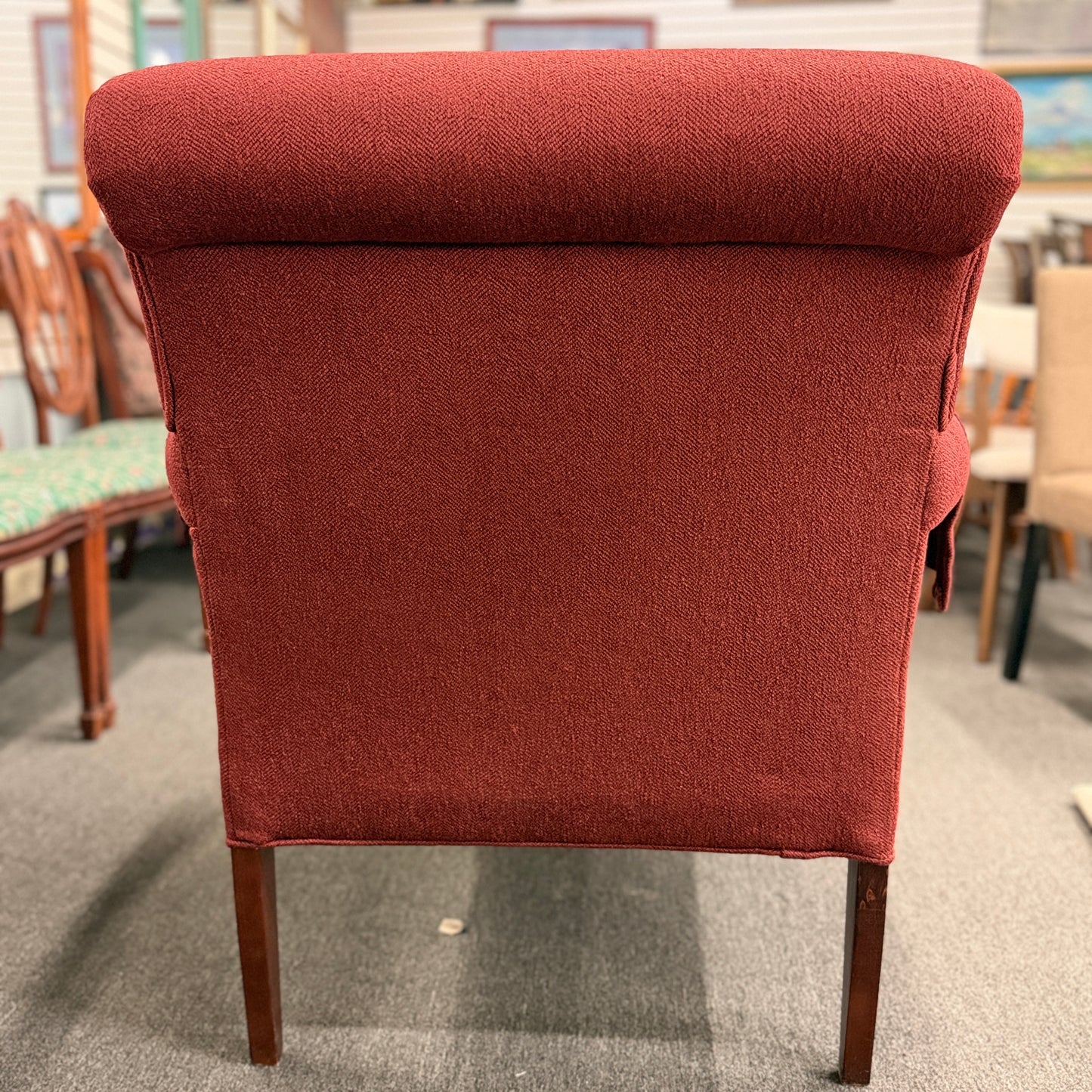 A contemporary plush fabric armchair featuring wide rounded track arms, a T-cushion seat, and a supportive square backrest.