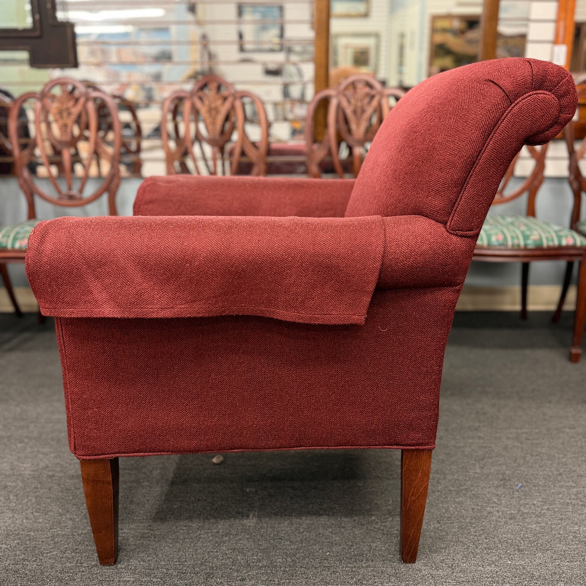 A contemporary plush fabric armchair featuring wide rounded track arms, a T-cushion seat, and a supportive square backrest.
