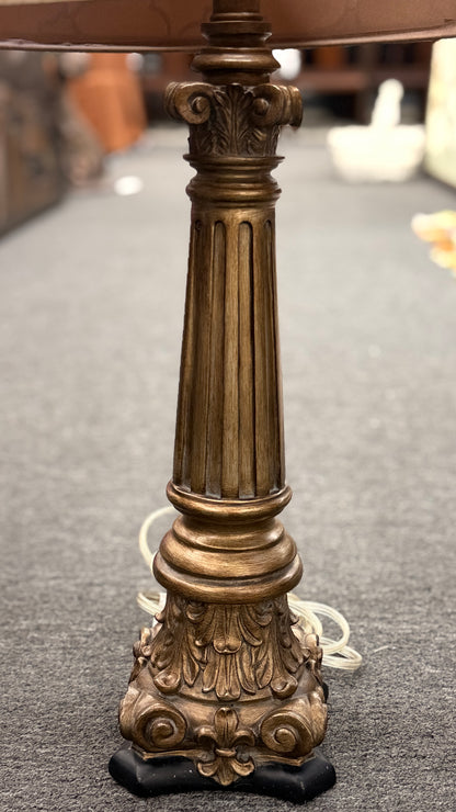 A matching pair of elegant table lamps with fluted column-style antique bronze bases and tan drum shades featuring a dark brown embroidered Moroccan trellis pattern.