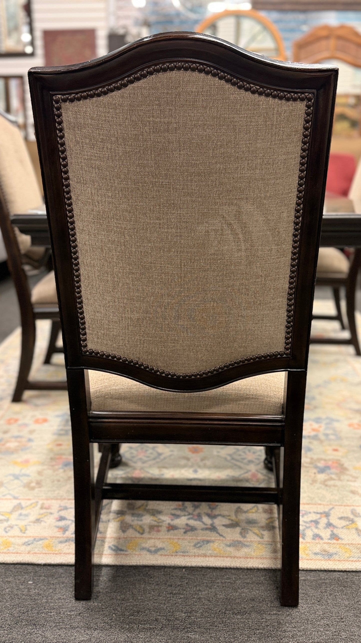 A traditional 7-piece dining set featuring a large rectangular wooden table, two high-back host armchairs, and four matching side chairs with fabric upholstery.