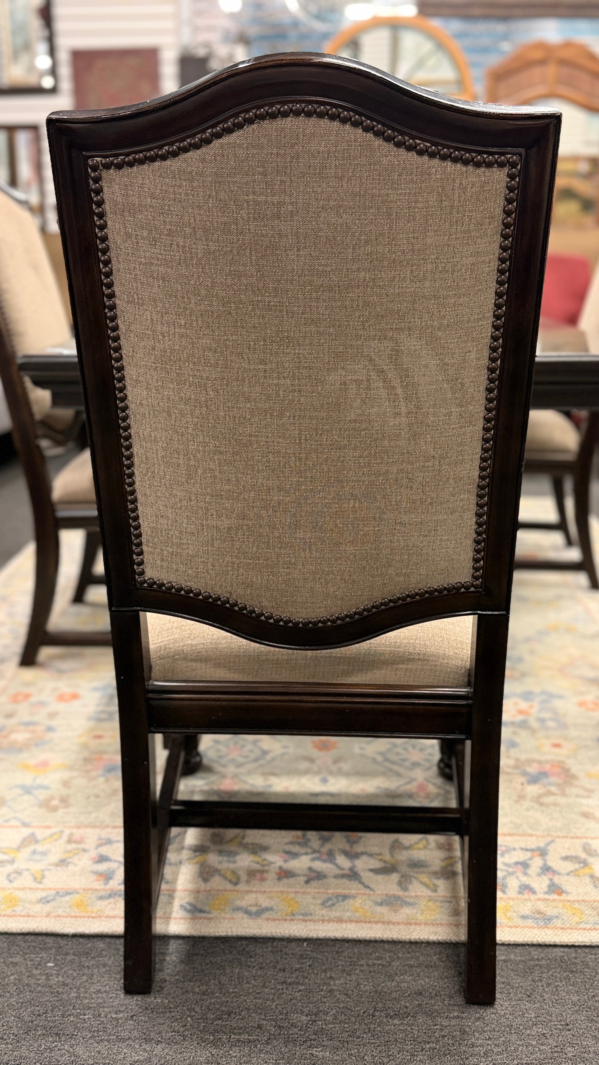 A traditional 7-piece dining set featuring a large rectangular wooden table, two high-back host armchairs, and four matching side chairs with fabric upholstery.