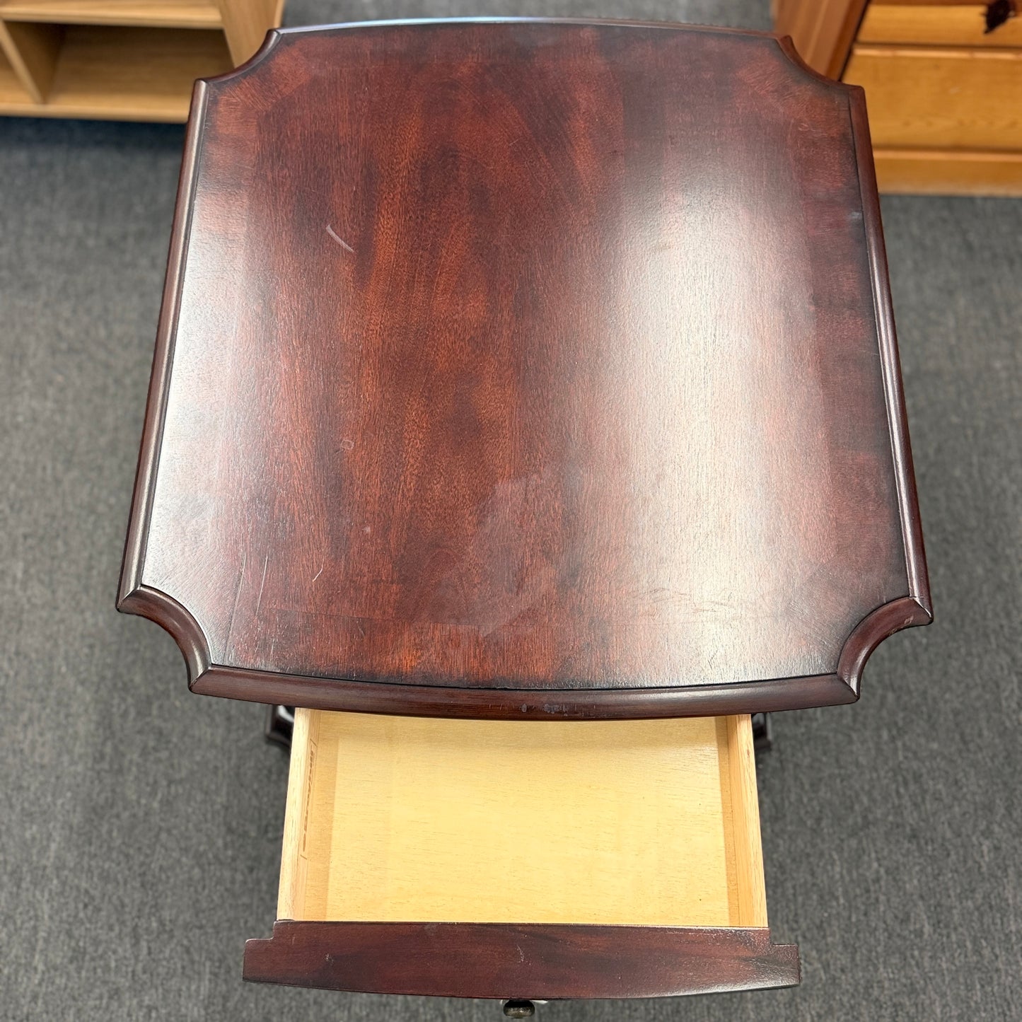Traditional dark wood nightstand featuring a top drawer, lower cabinet door, fluted corner details, and a classic timeless design.