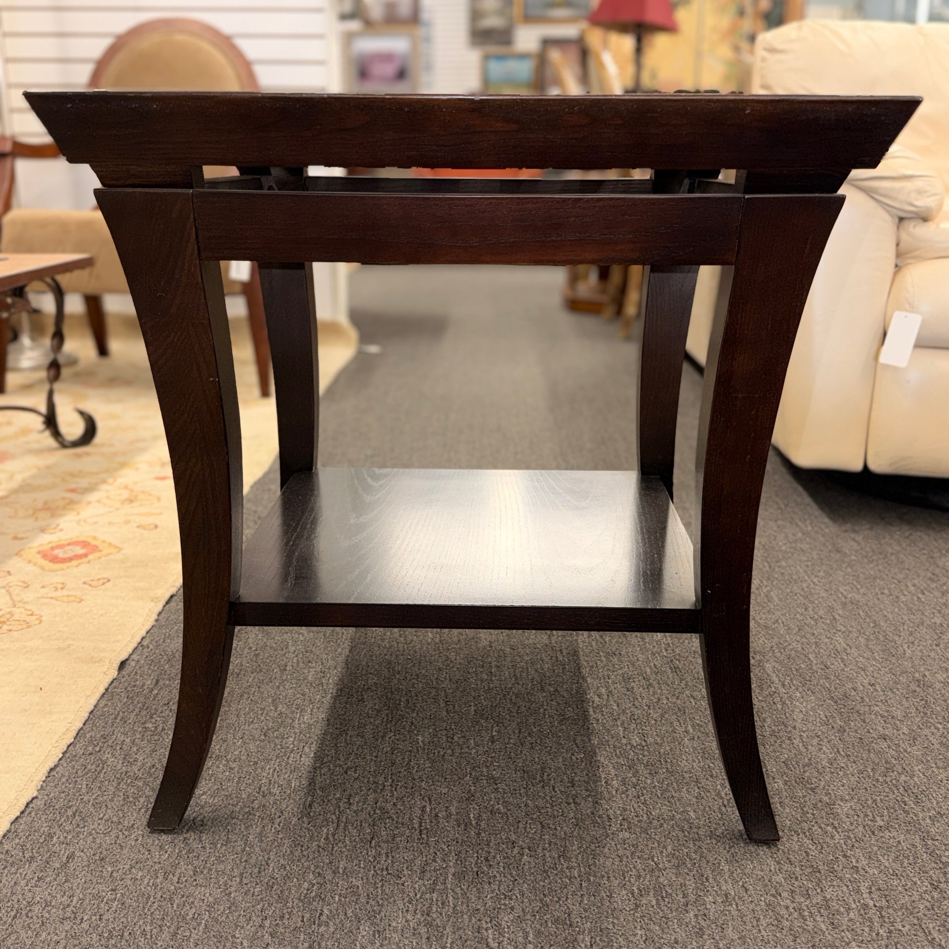 Square dark wood end table featuring a glass top with an intricate woven metal inlay and a lower display shelf.