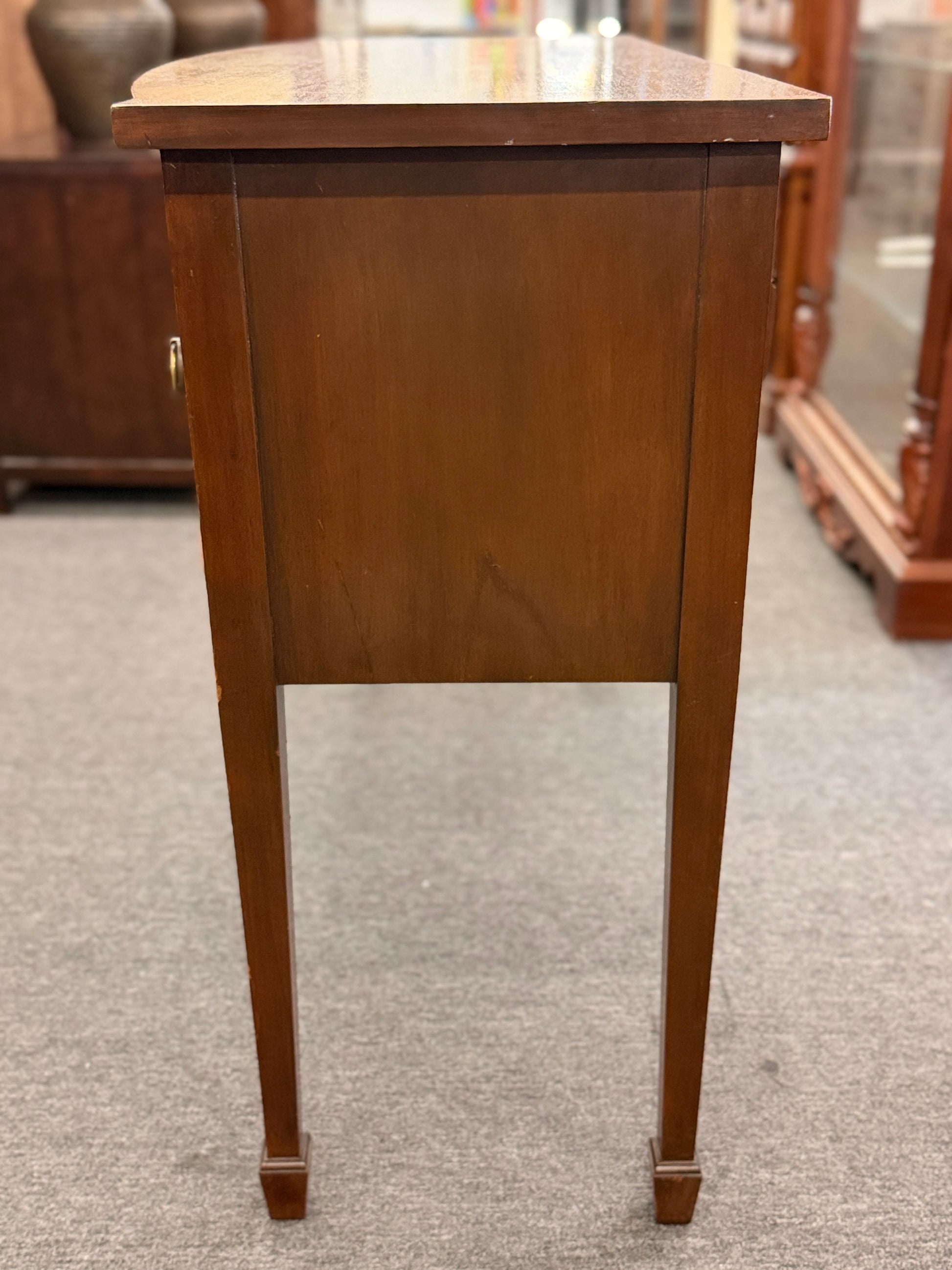 Traditional wood server featuring three front storage compartments with brass ring pulls, a scalloped bottom edge, and distinctive circular wood grain side panels.