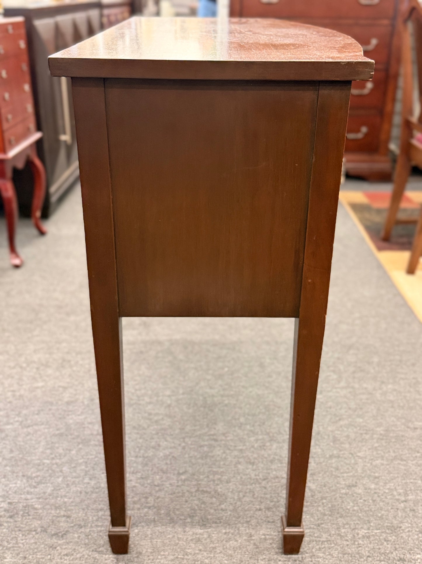 Traditional wood server featuring three front storage compartments with brass ring pulls, a scalloped bottom edge, and distinctive circular wood grain side panels.