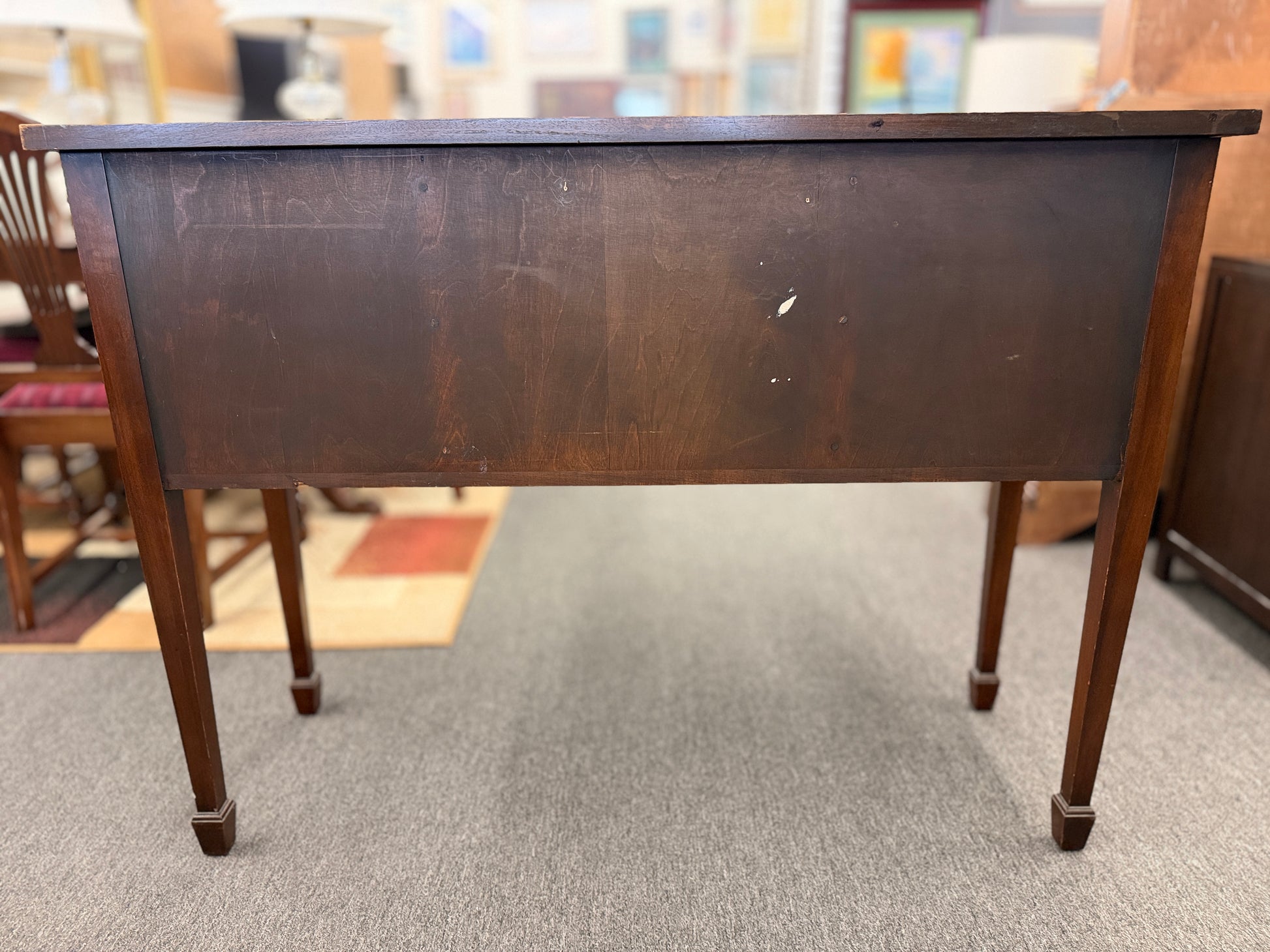 Traditional wood server featuring three front storage compartments with brass ring pulls, a scalloped bottom edge, and distinctive circular wood grain side panels.