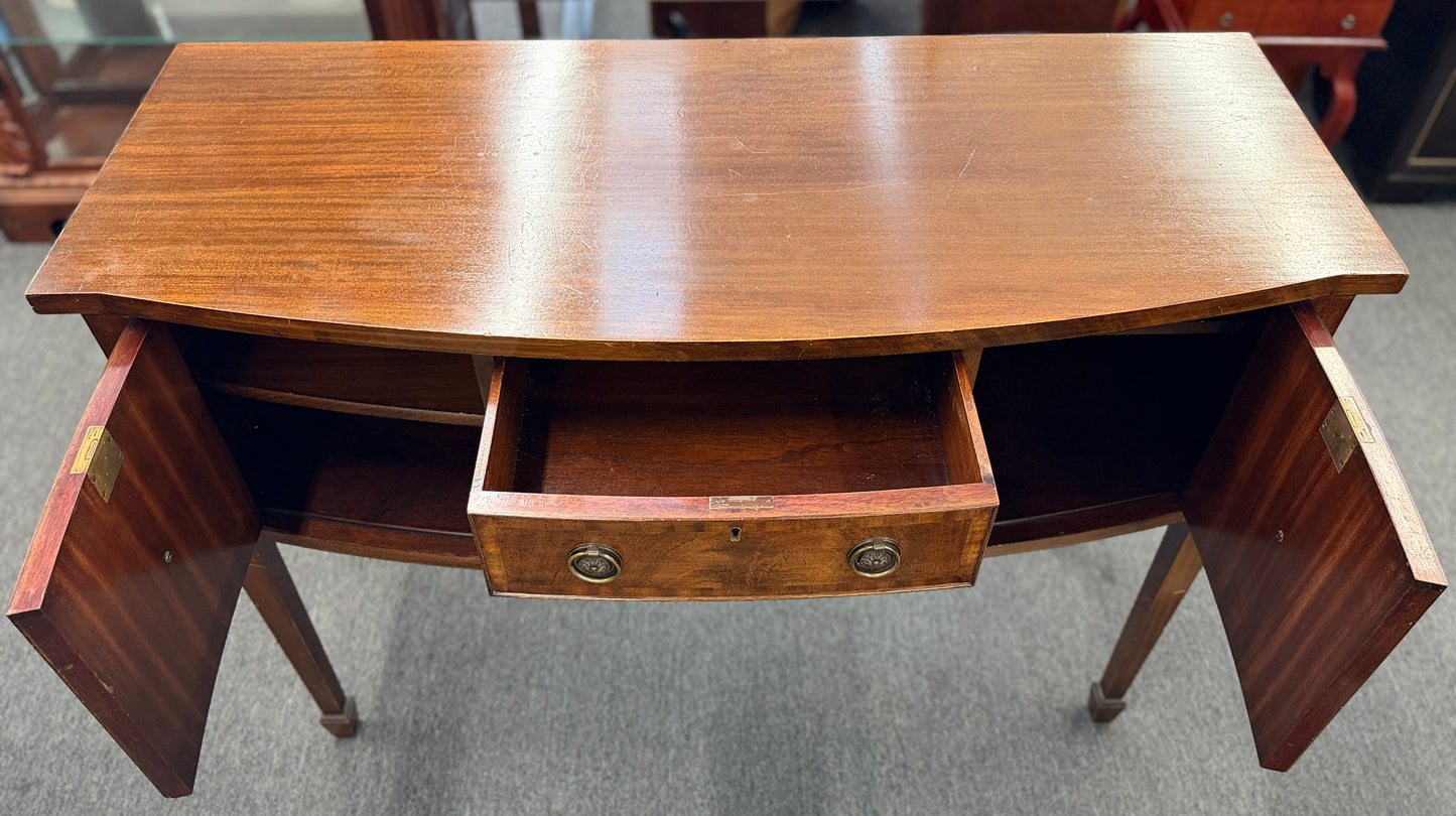 Traditional wood server featuring three front storage compartments with brass ring pulls, a scalloped bottom edge, and distinctive circular wood grain side panels.