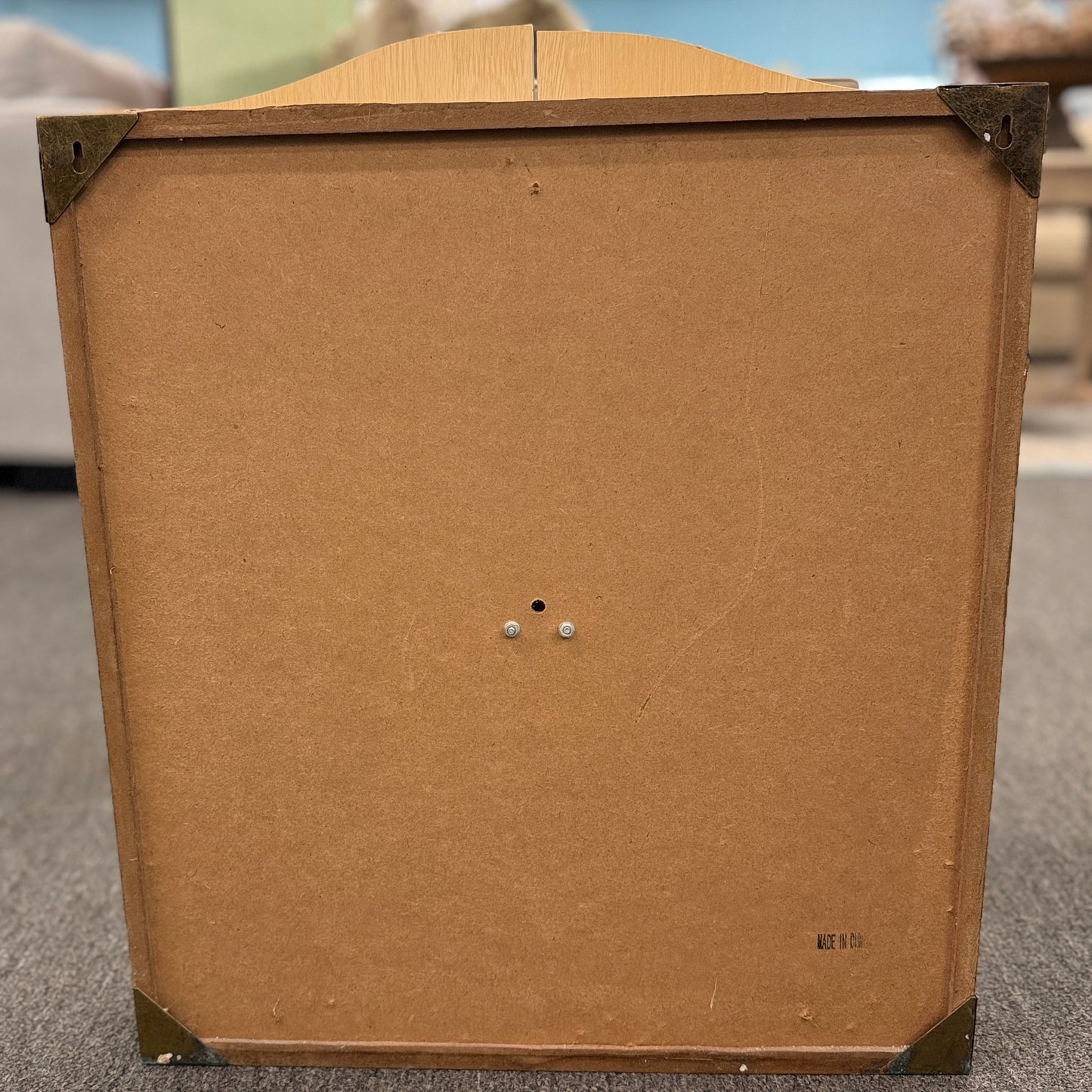 Wood dartboard cabinet opened to reveal a classic bristle dartboard with green Cricket scoreboards on the inside of both cabinet doors.