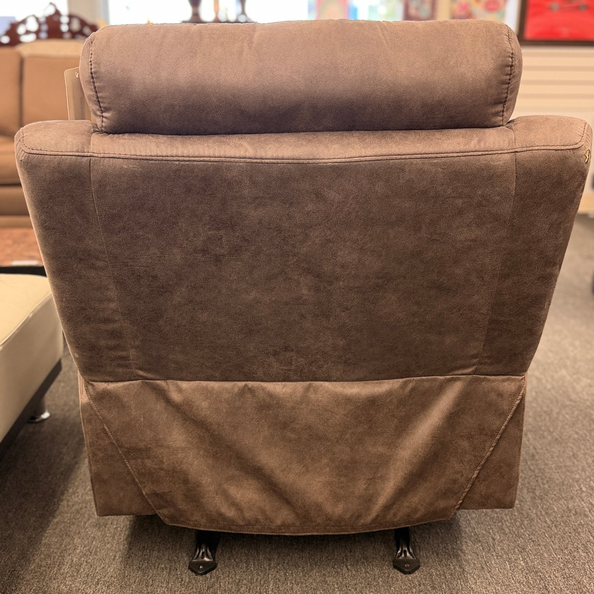 A plush, overstuffed recliner chair in a soft, medium-brown fabric with thickly padded pillow-top armrests and deep back cushioning.