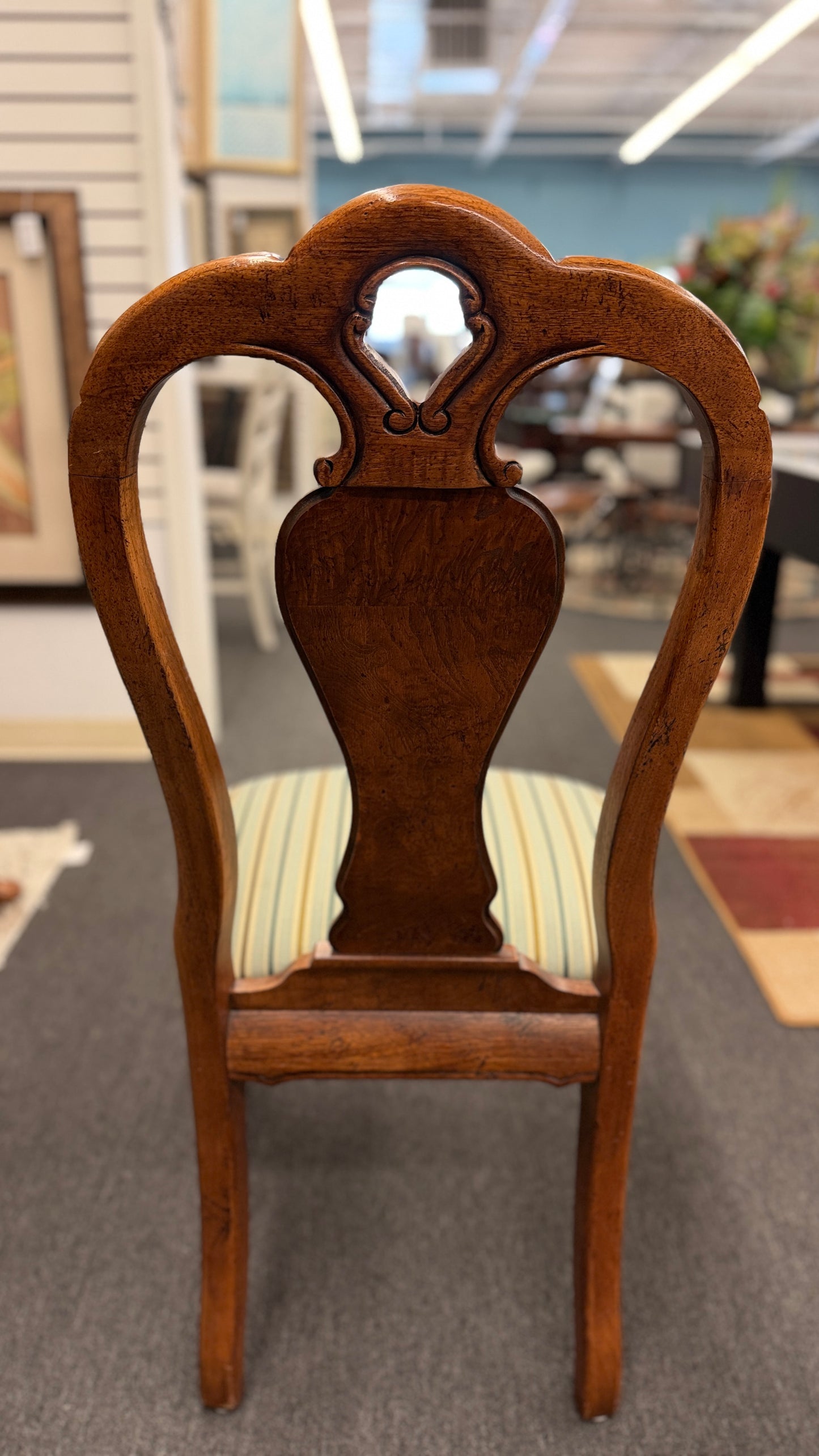 A 7-piece formal dining set featuring a marquetry wood inlay rectangular table with cabriole legs and six carved chairs with striped seats.