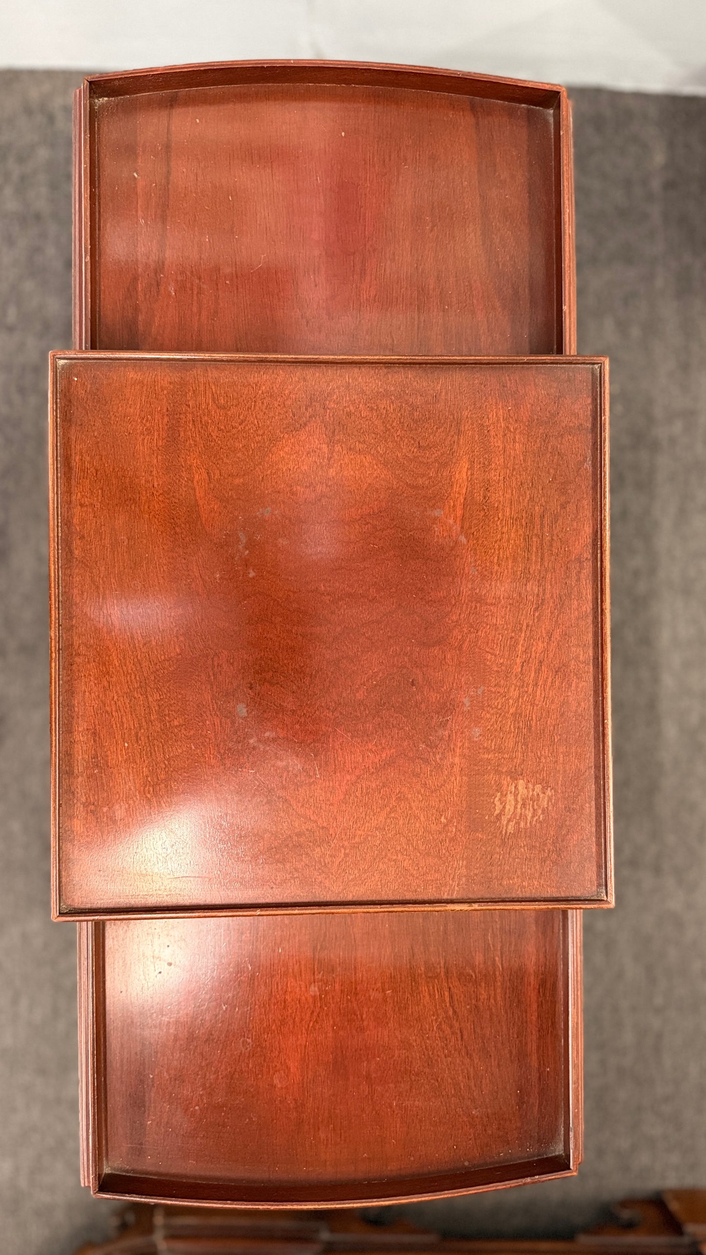 A classic mahogany-finished wooden console entry table featuring a center drawer with oval brass pull, tapered legs, and a lower shelf.