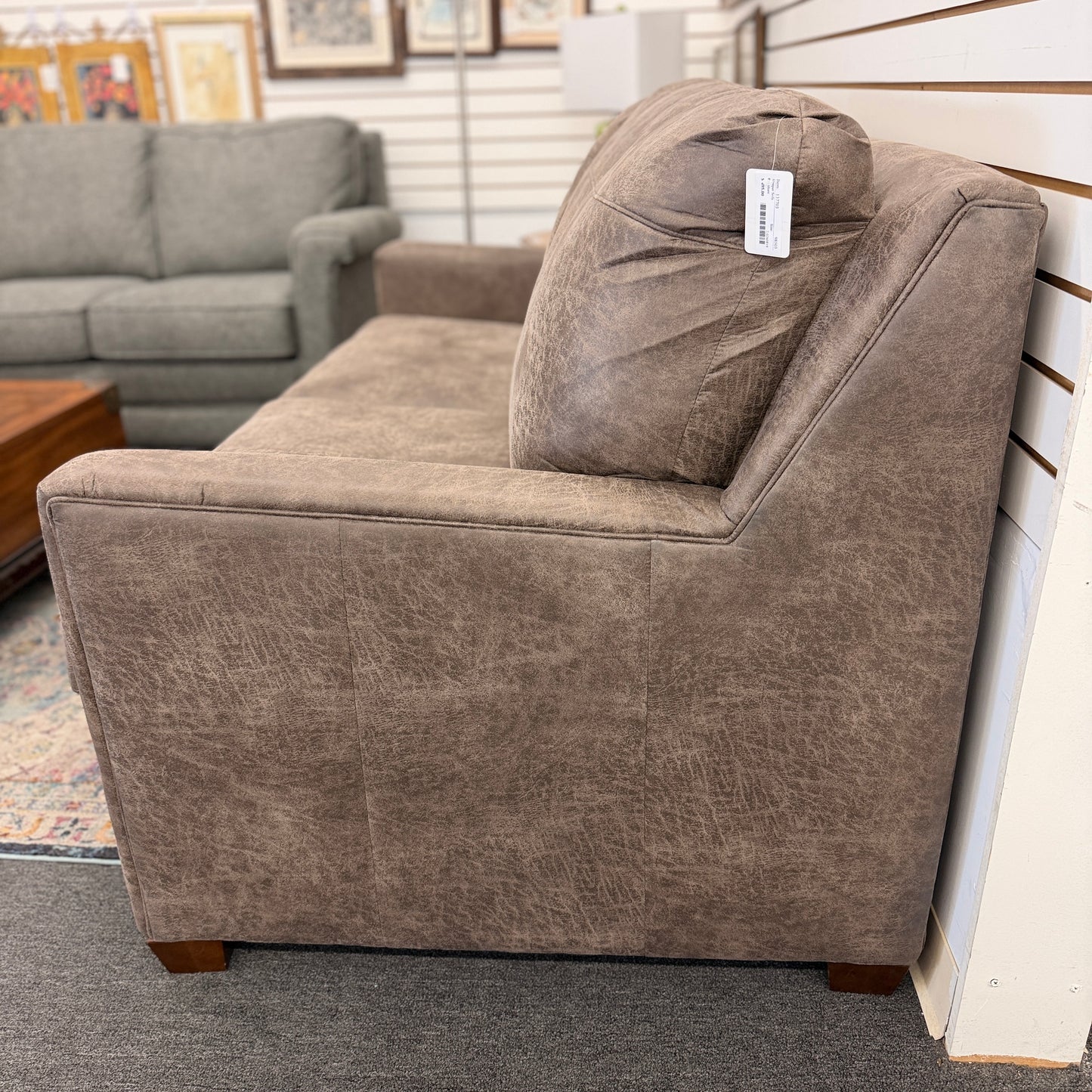 A plush two-seater sleeper sofa with pillow-top backrests and tapered track arms in textured distressed taupe-brown fabric.