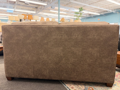 A plush two-seater sleeper sofa with pillow-top backrests and tapered track arms in textured distressed taupe-brown fabric.