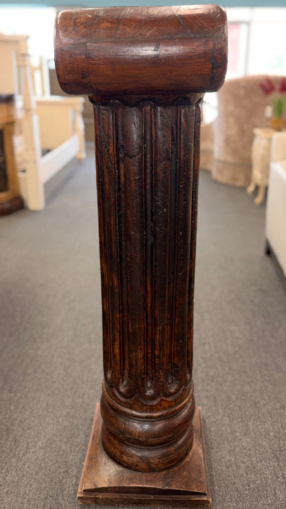 A classical wooden architectural pedestal featuring a carved Ionic scroll capital with floral motifs, a fluted shaft, and a square plinth base in excellent condition.