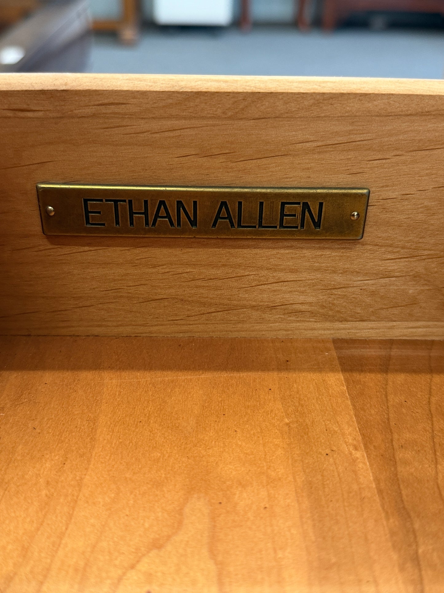 A traditional Ethan Allen wooden nightstand featuring a single top drawer, X-brace side panels, and an open lower shelf in good condition.