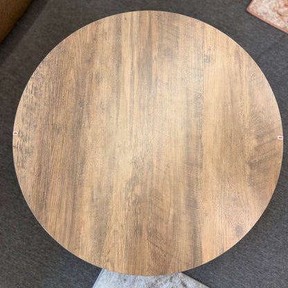 A round tiered wood-finish coffee table featuring a lift-top storage compartment in excellent condition.