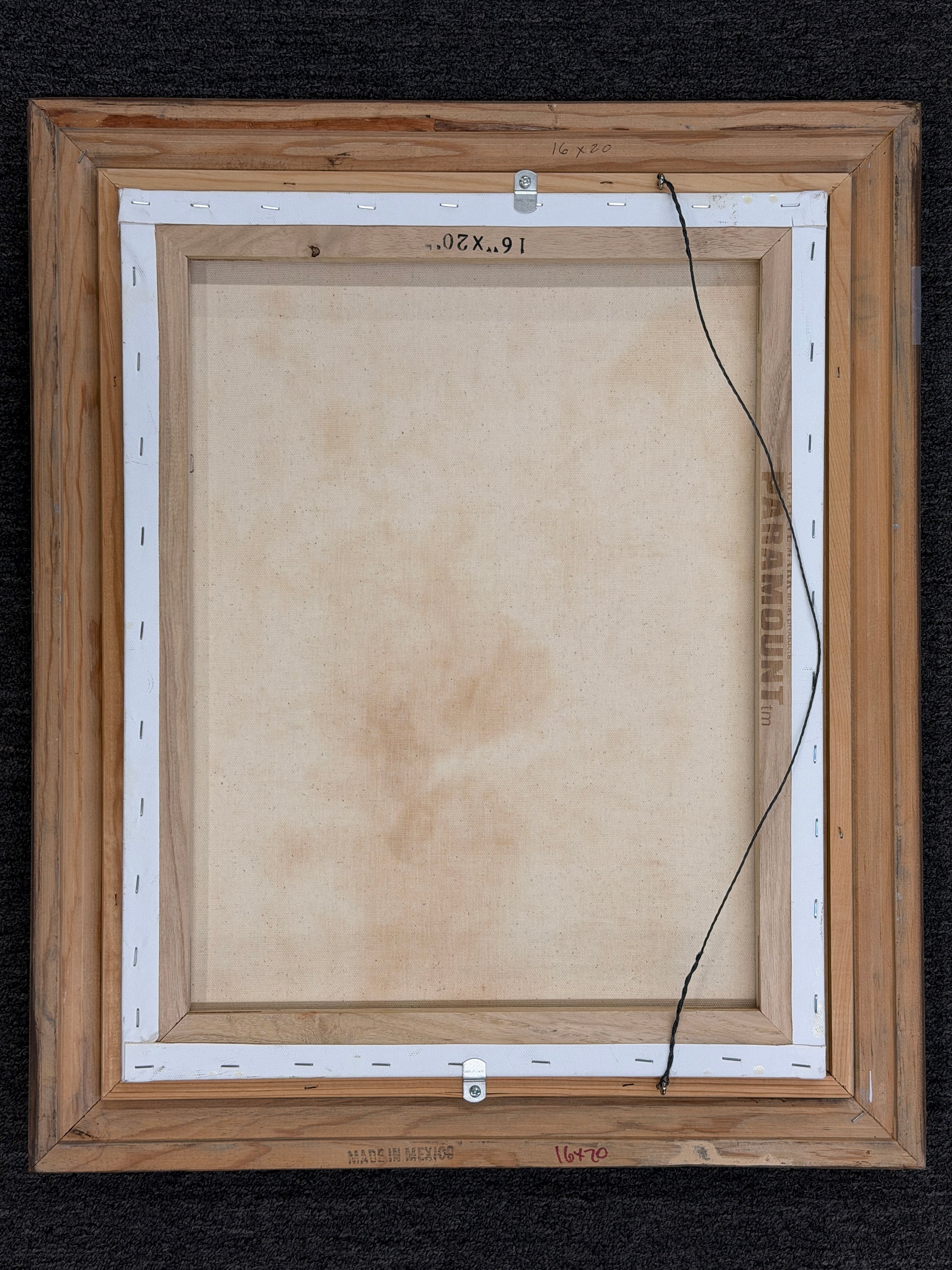 A framed Impressionist-style oil painting depicting a sunlit water lily pond, encased in a molded gray-blue and silver frame in excellent condition.