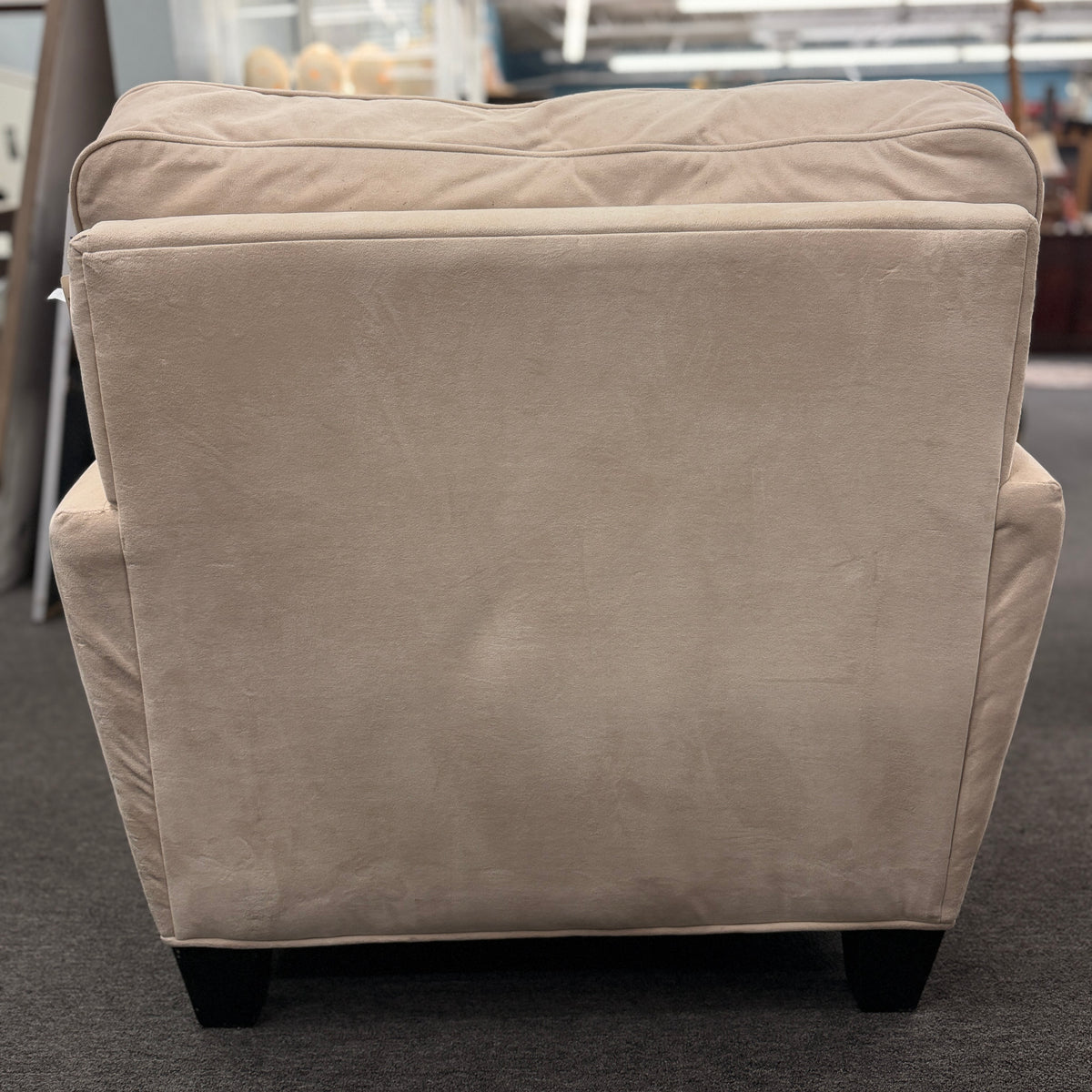 A contemporary single-seat chaise lounge upholstered in plush cream microfiber with track arms and a back cushion in good condition.
