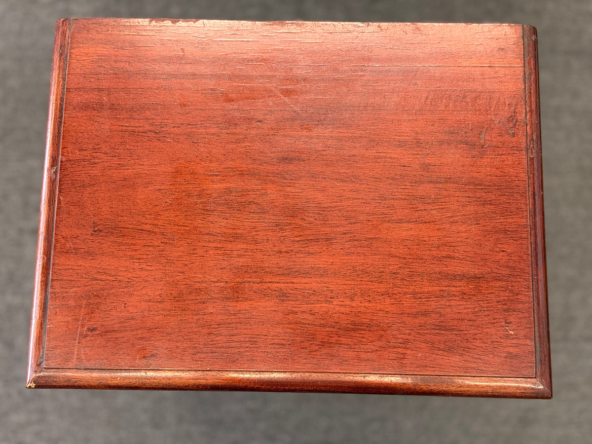 A Queen Anne-style two-drawer nightstand in rich mahogany featuring ornate brass hardware, cabriole legs, and ball-and-claw feet in good condition.