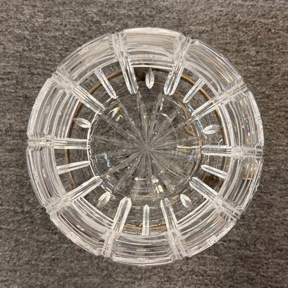 A geometric cut-crystal bowl set on an ornate antique brass-finished tripod stand in excellent condition.