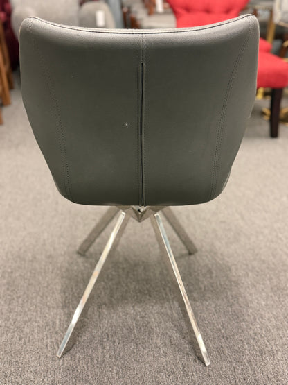An accent office chair featuring sleek charcoal-gray faux leather upholstery with stitched seams, set on four angled chrome legs in good condition.