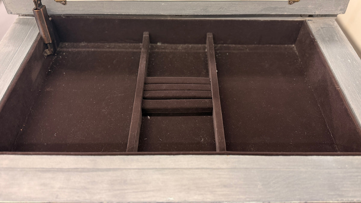 A tall slender Bassett jewelry armoire finished in distressed slate gray with white trim line detailing, six front drawers, and a flip-top lid with interior mirror in excellent condition.