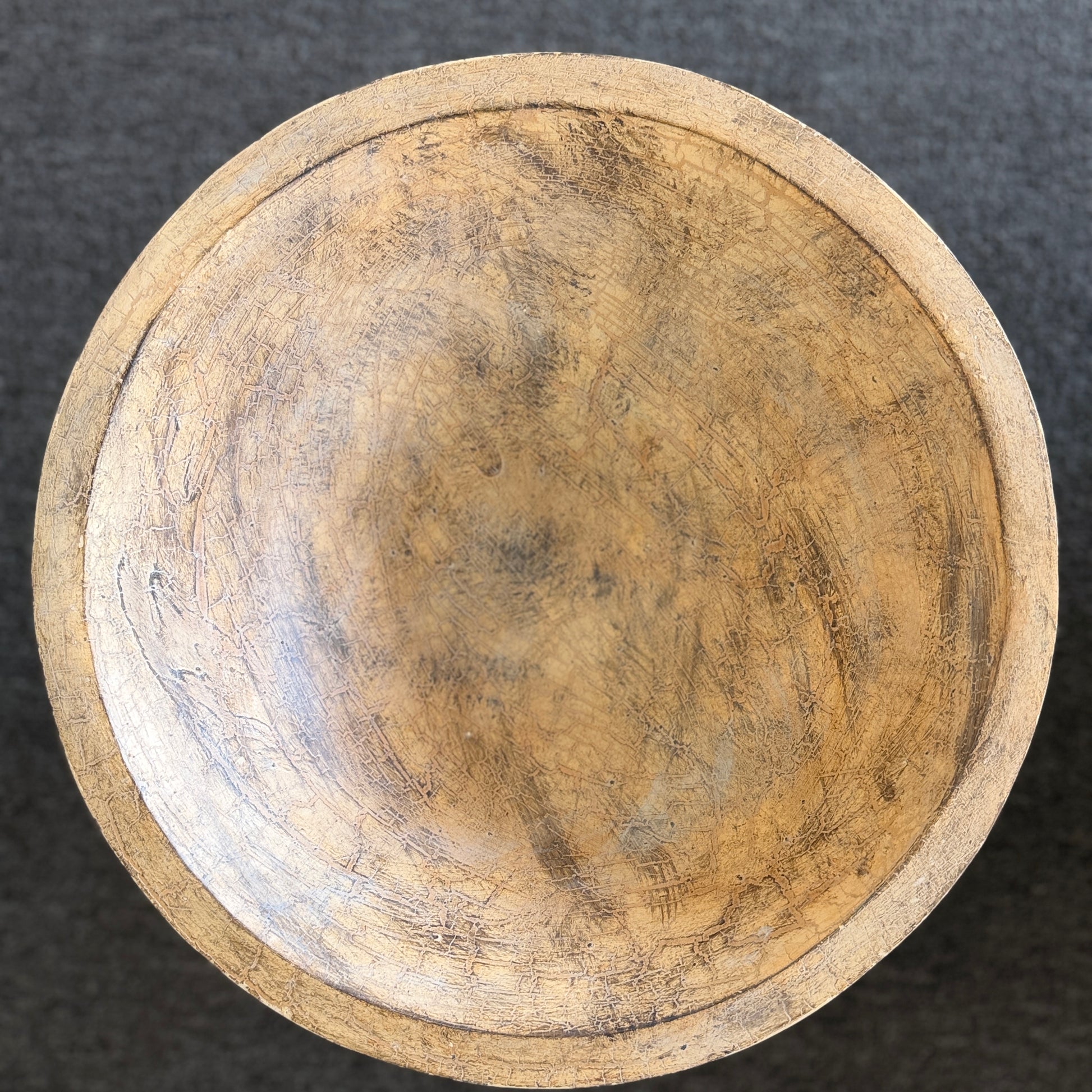 A decorative heavily textured ceramic lidded urn covered in overlapping leaf patterns with an antiqued distressed cream and brown finish.