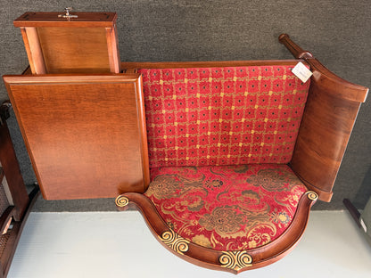 An antique-style wooden telephone chair featuring a single seat with red patterned upholstery, gold-accented scrollwork, an attached side tabletop, and a drawer in excellent condition.