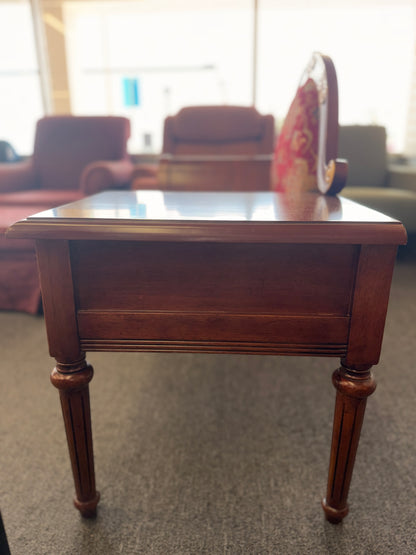 An antique-style wooden telephone chair featuring a single seat with red patterned upholstery, gold-accented scrollwork, an attached side tabletop, and a drawer in excellent condition.