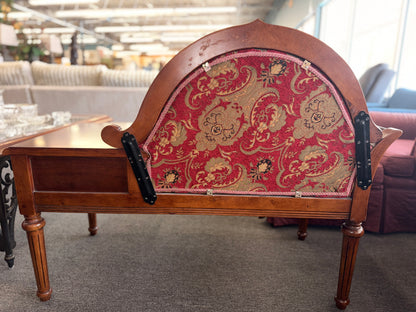 An antique-style wooden telephone chair featuring a single seat with red patterned upholstery, gold-accented scrollwork, an attached side tabletop, and a drawer in excellent condition.