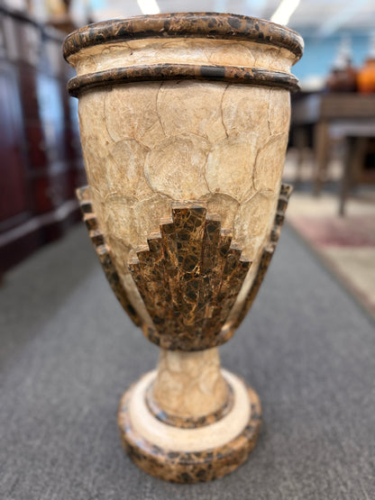 A tall Art Deco-inspired decorative vase featuring a textured light capiz-style overlapping circular pattern body with dark faux-marble geometric stepped accents and base.