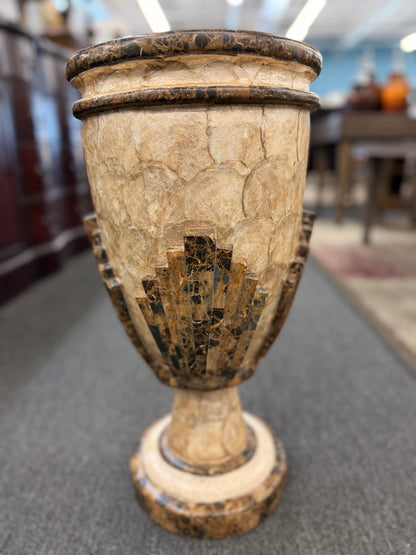 A tall Art Deco-inspired decorative vase featuring a textured light capiz-style overlapping circular pattern body with dark faux-marble geometric stepped accents and base.