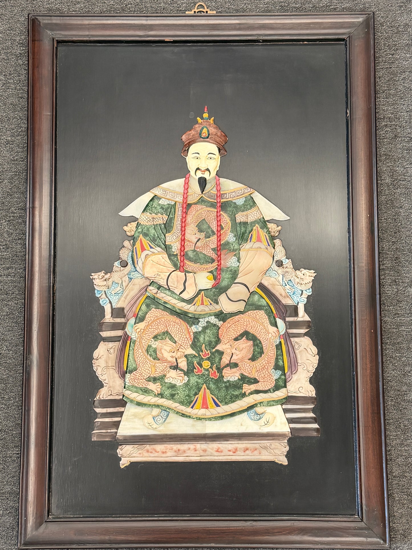 Traditional Asian emperor portrait framed wall art featuring an enthroned figure with green and gold 3D textured accents in a dark wood frame at 2nd Debut Houston consignment showroom