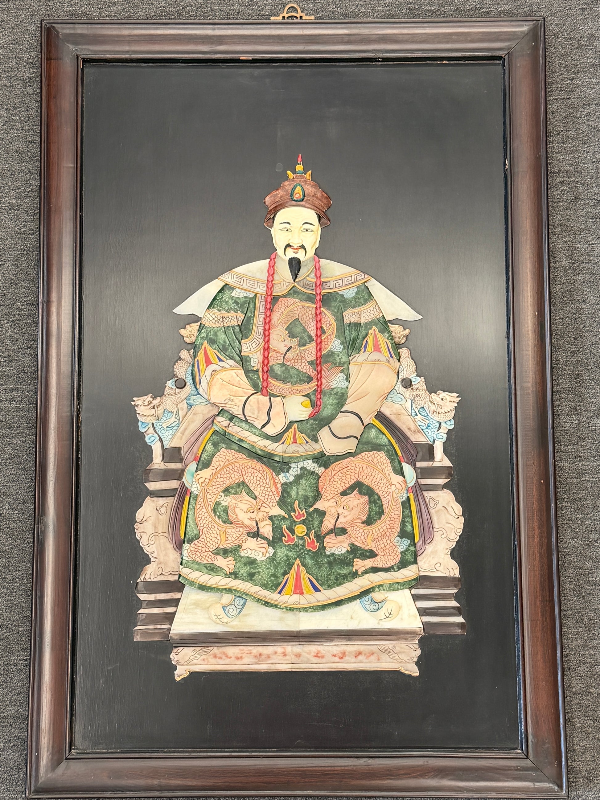 Traditional Asian emperor portrait framed wall art featuring an enthroned figure with green and gold 3D textured accents in a dark wood frame at 2nd Debut Houston consignment showroom