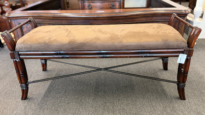 A wooden bench featuring bamboo-style framing, metal cross-stretchers, and a brown upholstered seat in good condition.