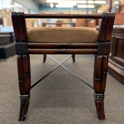 A wooden bench featuring bamboo-style framing, metal cross-stretchers, and a brown upholstered seat in good condition.