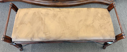 A wooden bench featuring bamboo-style framing, metal cross-stretchers, and a brown upholstered seat in good condition.