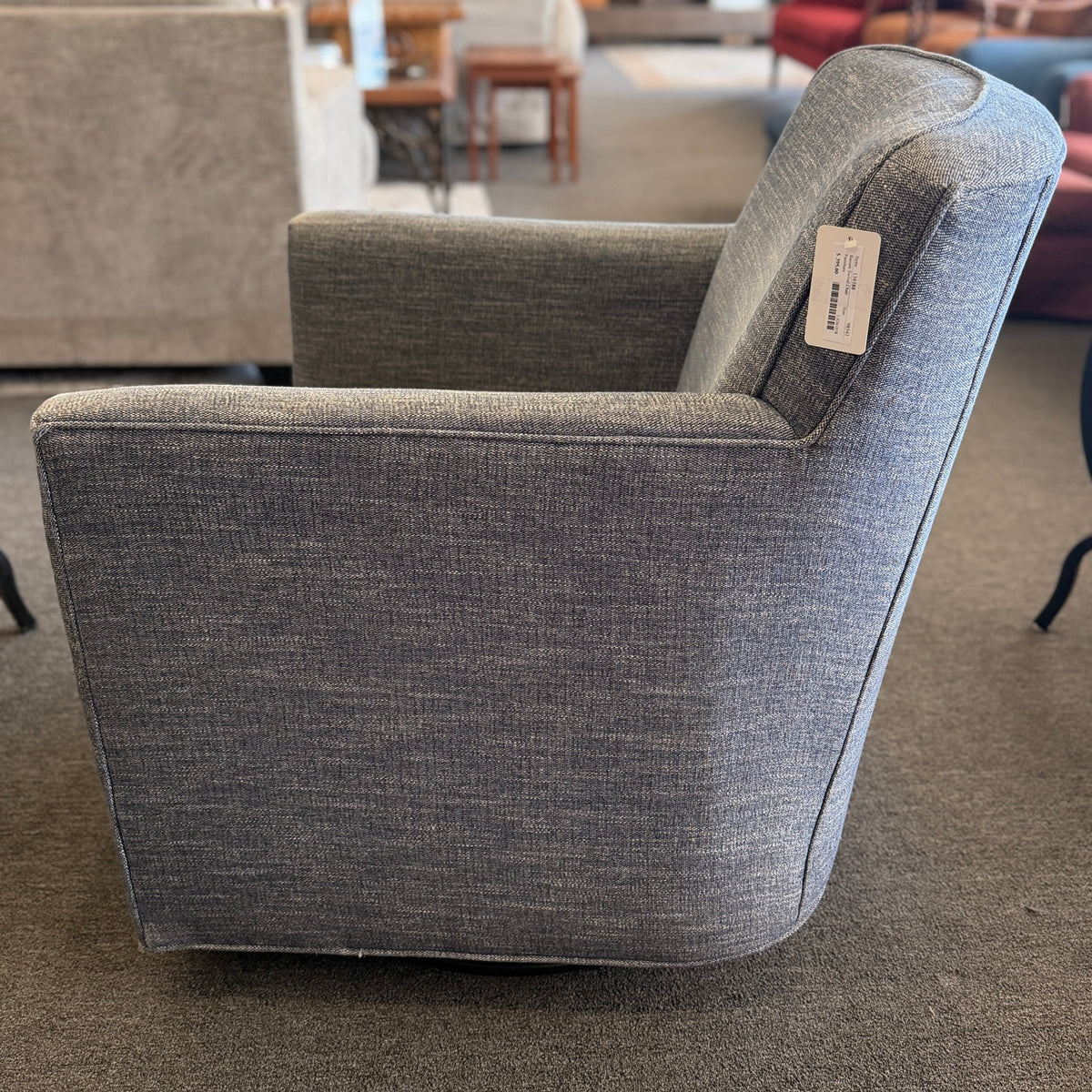A classic Bassett armchair upholstered in a textured light grayish-blue fabric in excellent condition.