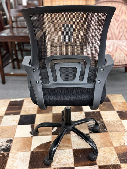 A standard black office chair with a breathable mesh backrest, padded fabric seat cushion, fixed armrests, and a five-point rolling star base.