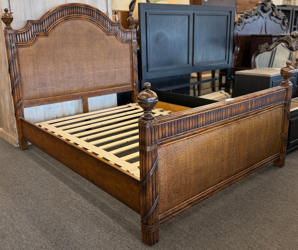 Carved wooden queen bed frame featuring arched woven rattan and cane panels on the headboard and footboard, accented with fluted posts and finials in excellent condition.