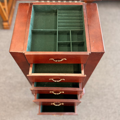A tall cherry-finished wooden jewelry cabinet on cabriole legs featuring pull-out drawers, swinging side doors, and a flip-top vanity mirror.